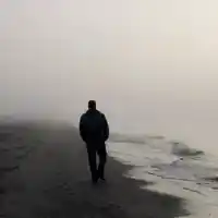 Alone man walking on the beach